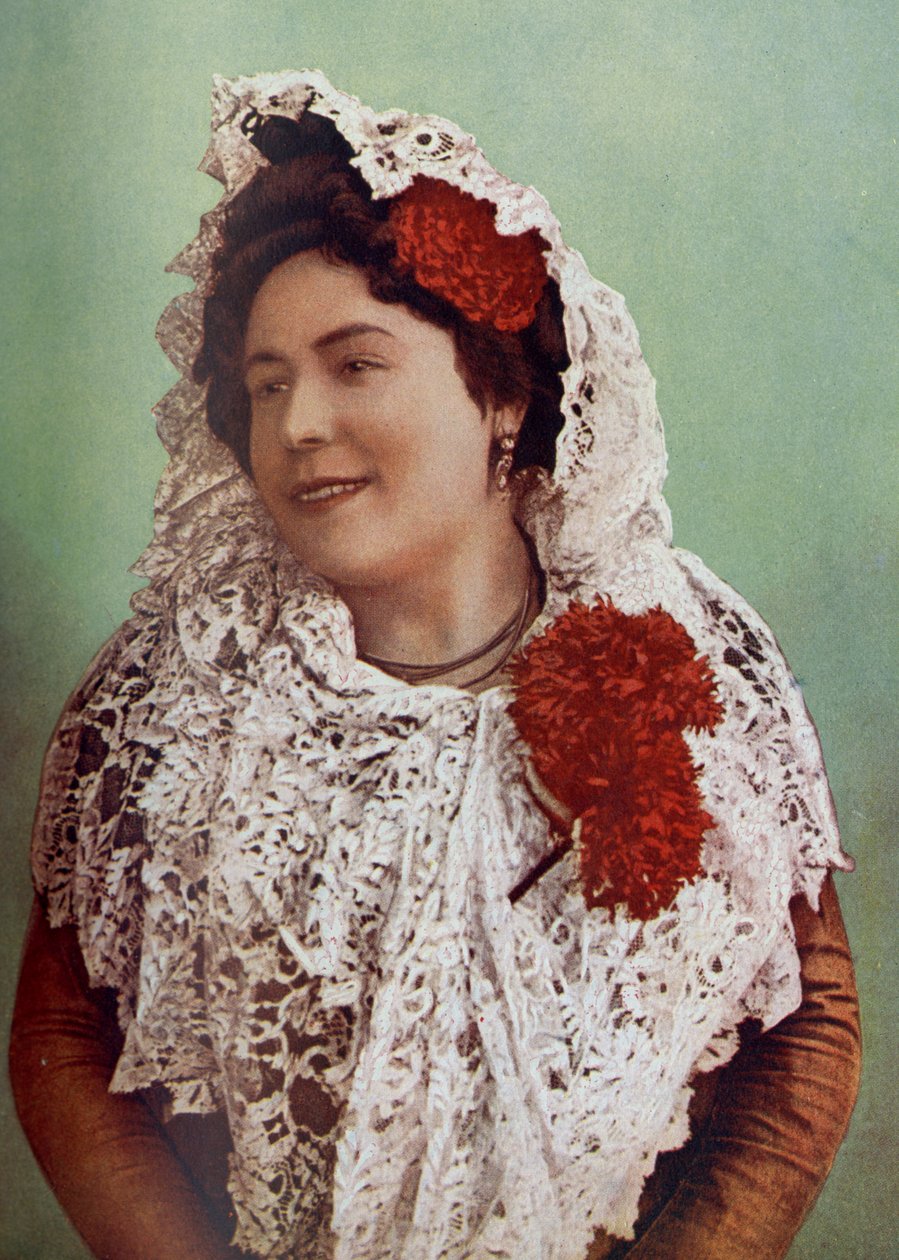 Spanien. Skarlagensrøde blomster og hvid blondemantilla draperet over hår og skuldre viser til fordel den andalusiske skønhed i syd. 1920 af Unknown