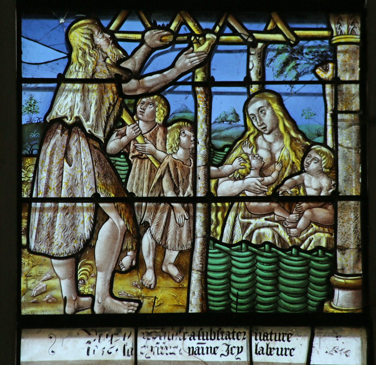 Vindue, der viser Adam, der bygger et hus, og Eva opdrager børn af French School