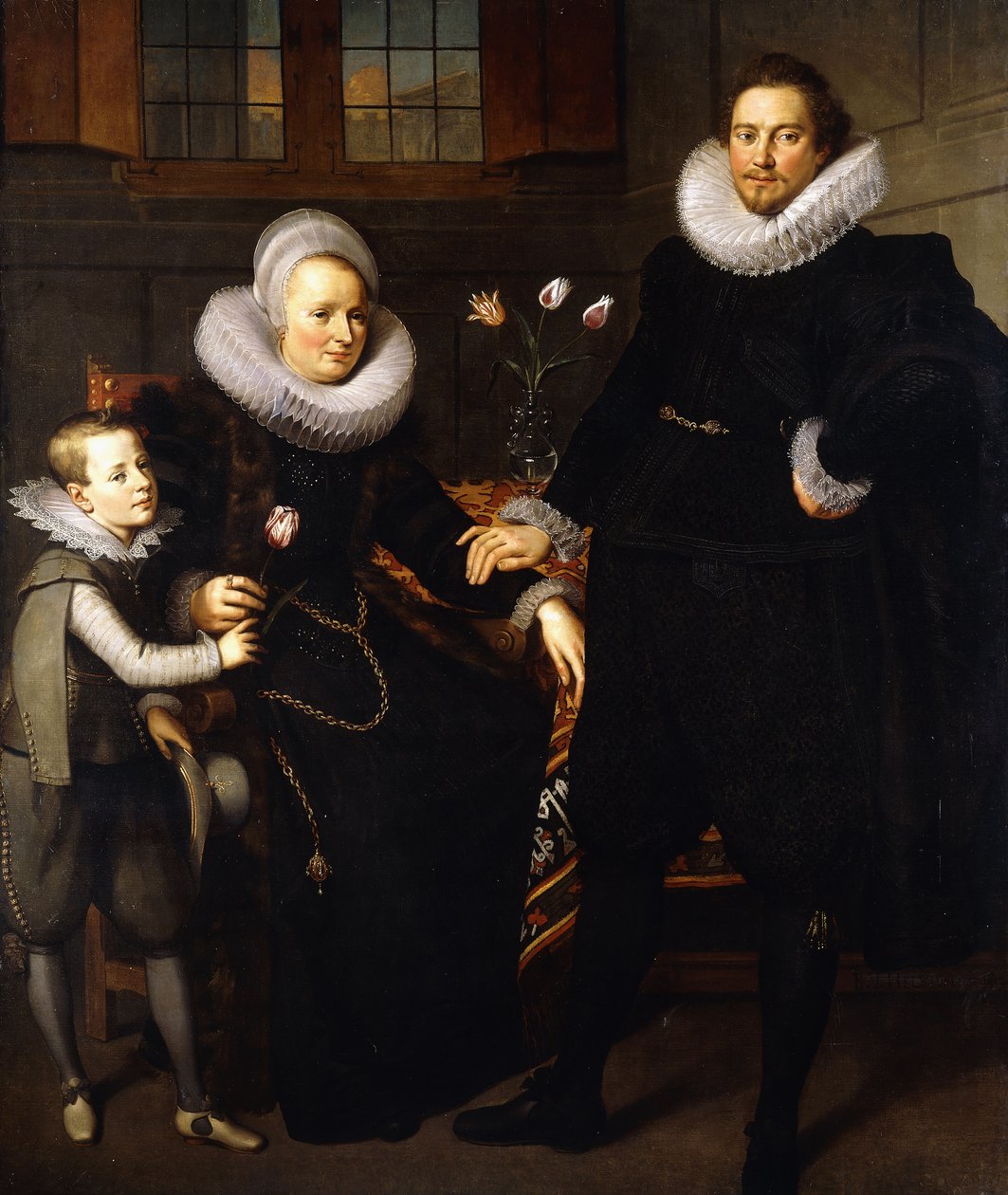 Et gruppeportræt af en familie, i fuld længde, i et interiør af Adam van Noort