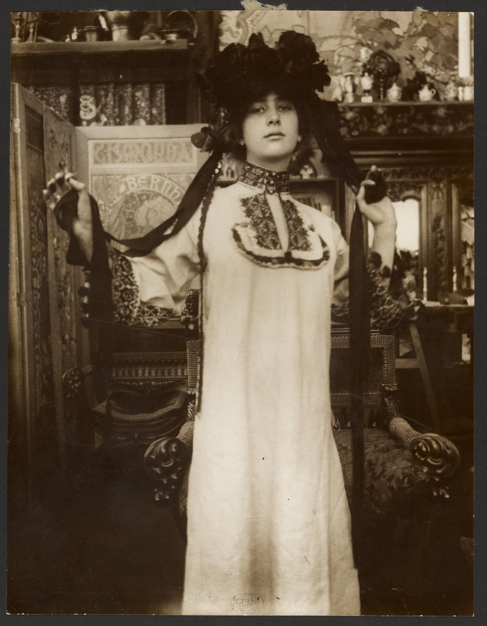 [Kvindelig model i en lang hvid kappe og en hat med bånd, Paris]. af Alphonse Maria Mucha