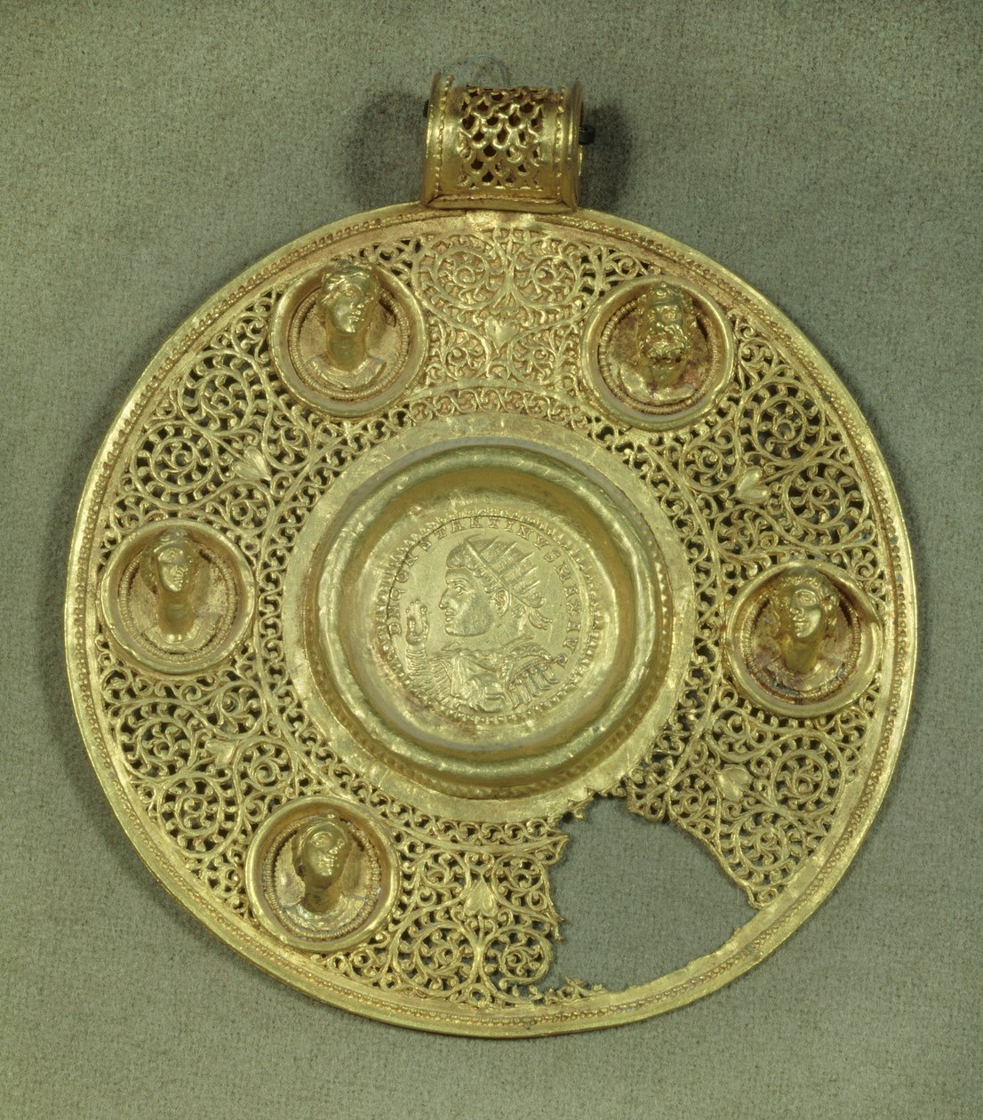 Cirkulær guldmedaljon: solidus af Konstantin I den Store (270-337 e.Kr.) rammer Sirmium i 321 e.Kr., i en opus interrasile ramme, prydet med 5 reliefbuster. 4. århundrede e.Kr. Søn 0.092 m Paris, Musée du Louvre af Byzantine