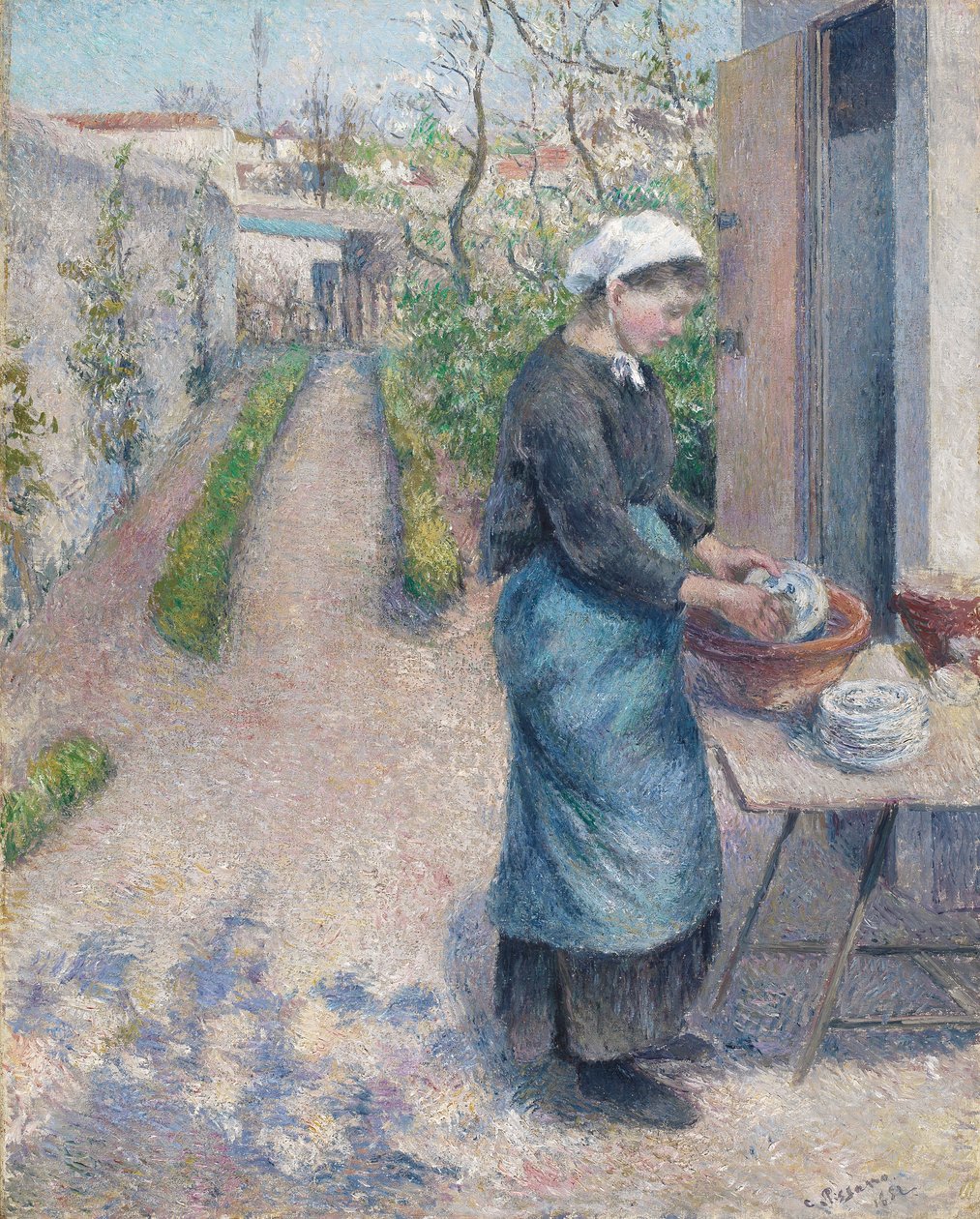 In the Garden at Pontoise: A Young Woman Washing Dishes, 1882 af Camille Jacob Pissarro