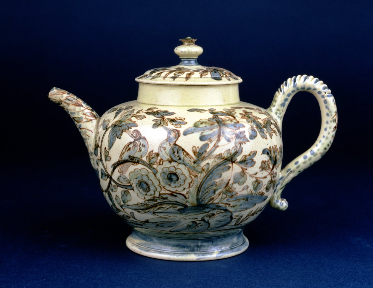Staffordshire Creamware tekande kendt som The Tunstall Teapot dekoreret med tre fugle i orientalsk løv, malet i brunlig mangan omridset forstærket i blå og grøn underglasur af F. Morg af English School