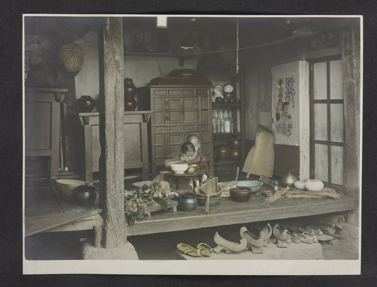 To børn spiser, inde i et hus, Fotoalbum af Korea af English Photographer