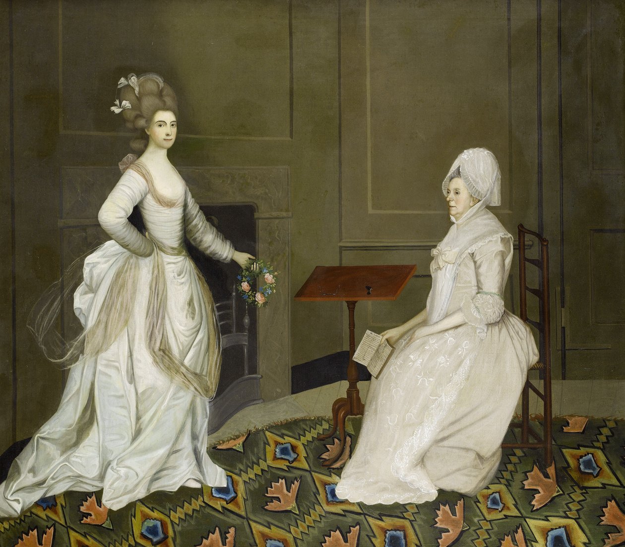 To damer i et interiør, den ene læser, den anden holder en blomsterkrans af English School, 18th Century