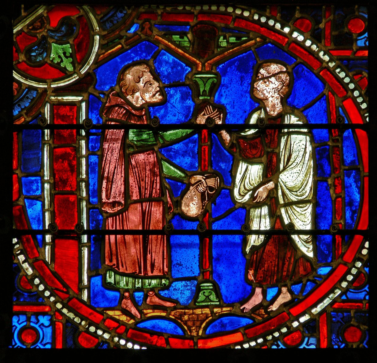 Detalje fra et vindue, der viser scener fra Theophilus