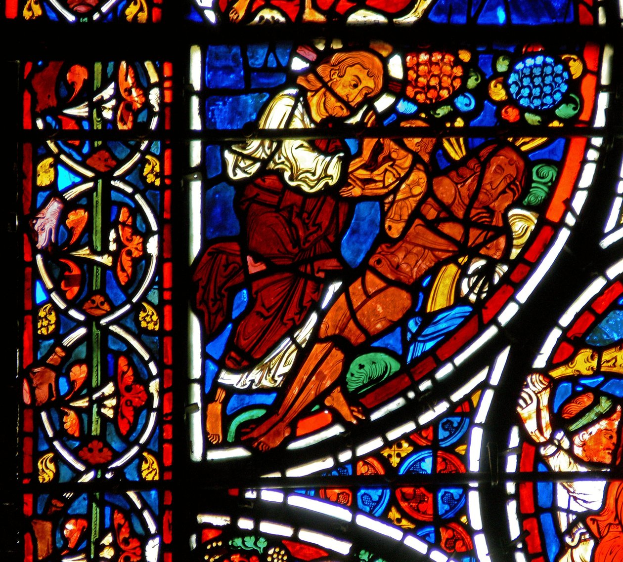Detalje fra et vindue, der viser lignelsen om den barmhjertige samaritaner: Evas skabelse af French School