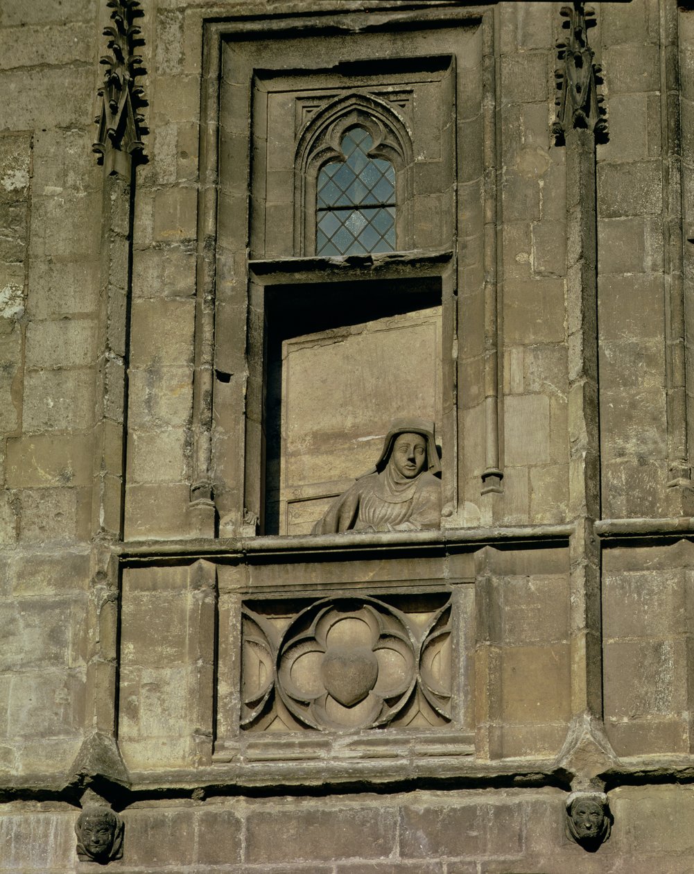 Dummyvindue i indgangsfacaden med en figur af en kvinde, der kigger ud, muligvis Jacques Coeur