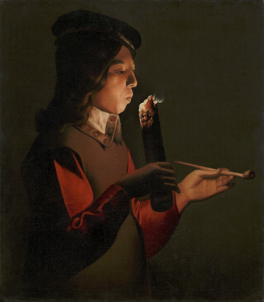 En ung dreng med en pibe, der blæser på en ildsjæl, af La Tour, Georges, de (1583-1652). olie på lærred af Georges de La Tour