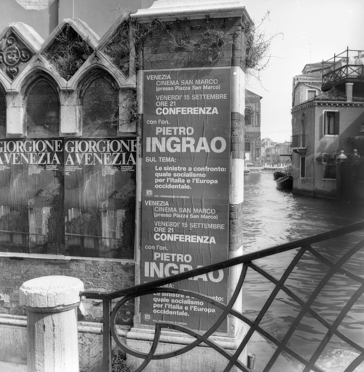 Udsigt over en kanal i Venedig med plakater, der reklamerer for en Giorgione-udstilling og et politisk manifest i forgrunden af Italian Photographer