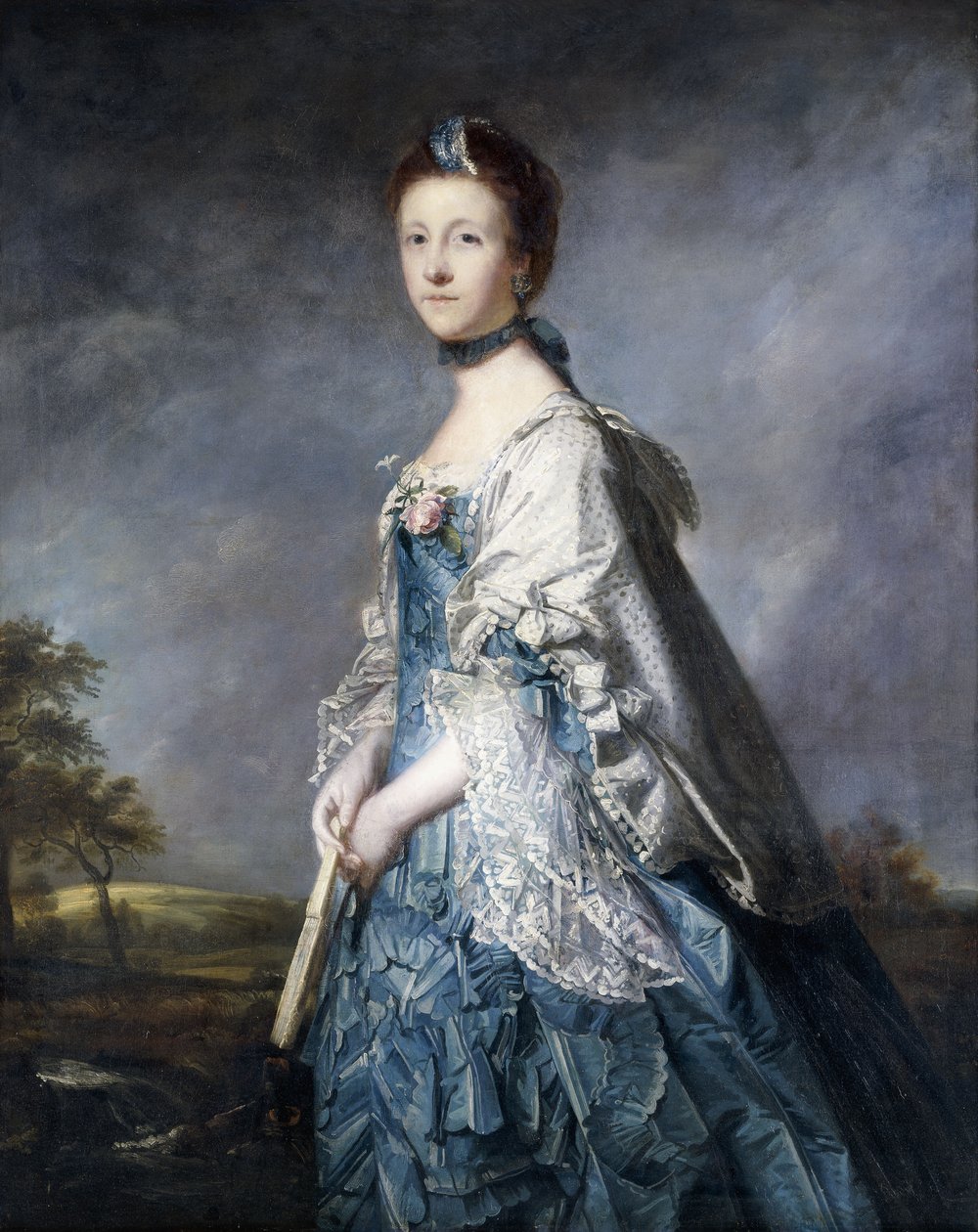 Portræt af Anne, grevinde Winterton, stående trekvart længde, iført en blå kjole, og blondeklippet sjal, holder en vifte, i et landskab, af Joshua Reynolds