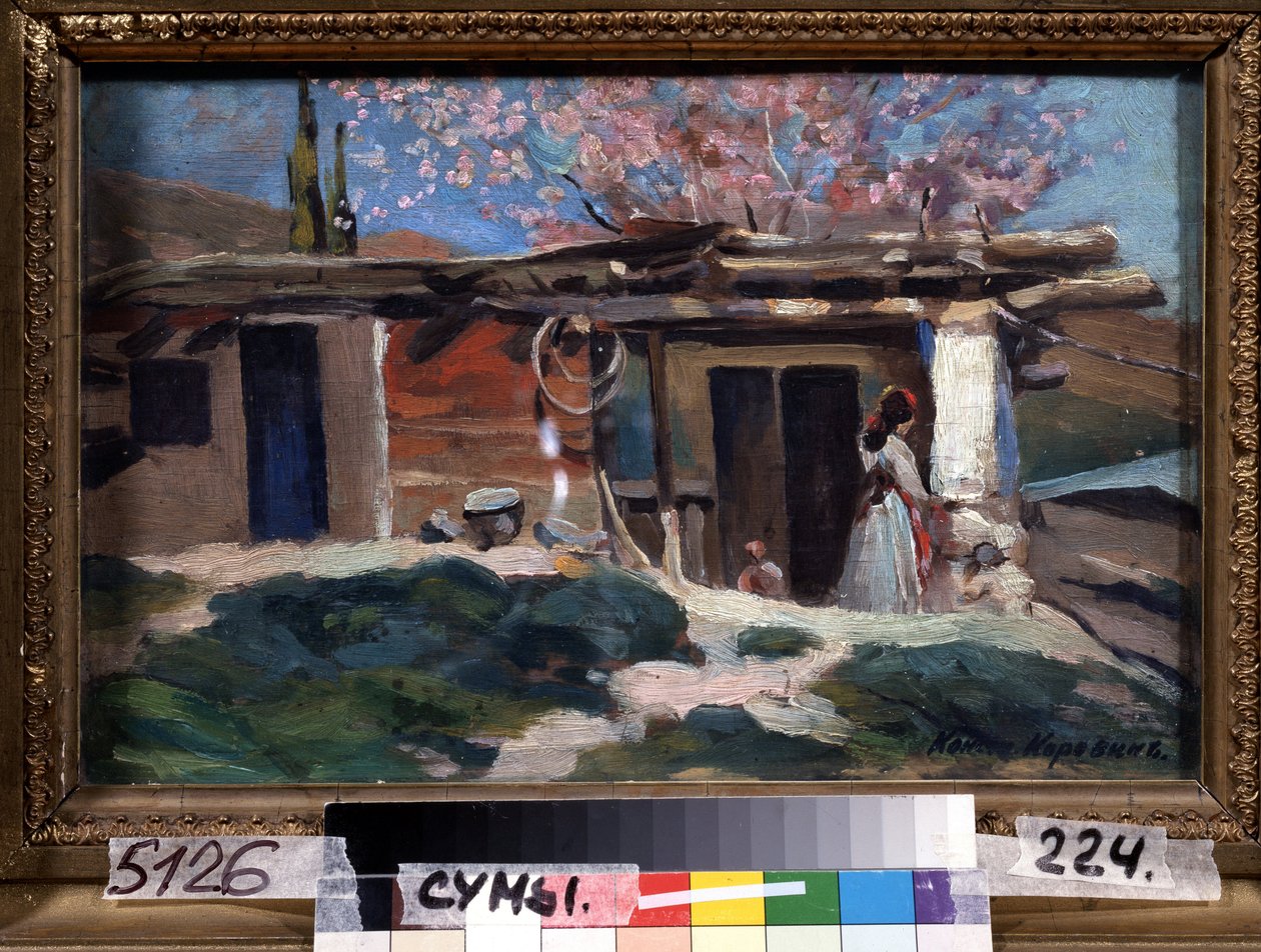 Krim, mandeltræer i blomst. (Krim, blomstrende mandeltræer). Ung kvinde foran et lille træhus, under lyserøde mandeltræer. Maleri af Konstantin Alexeyevich Korovin (Constantin Korovin) (1861-1939), olie på lærred af Konstantin Alekseevich Korovin