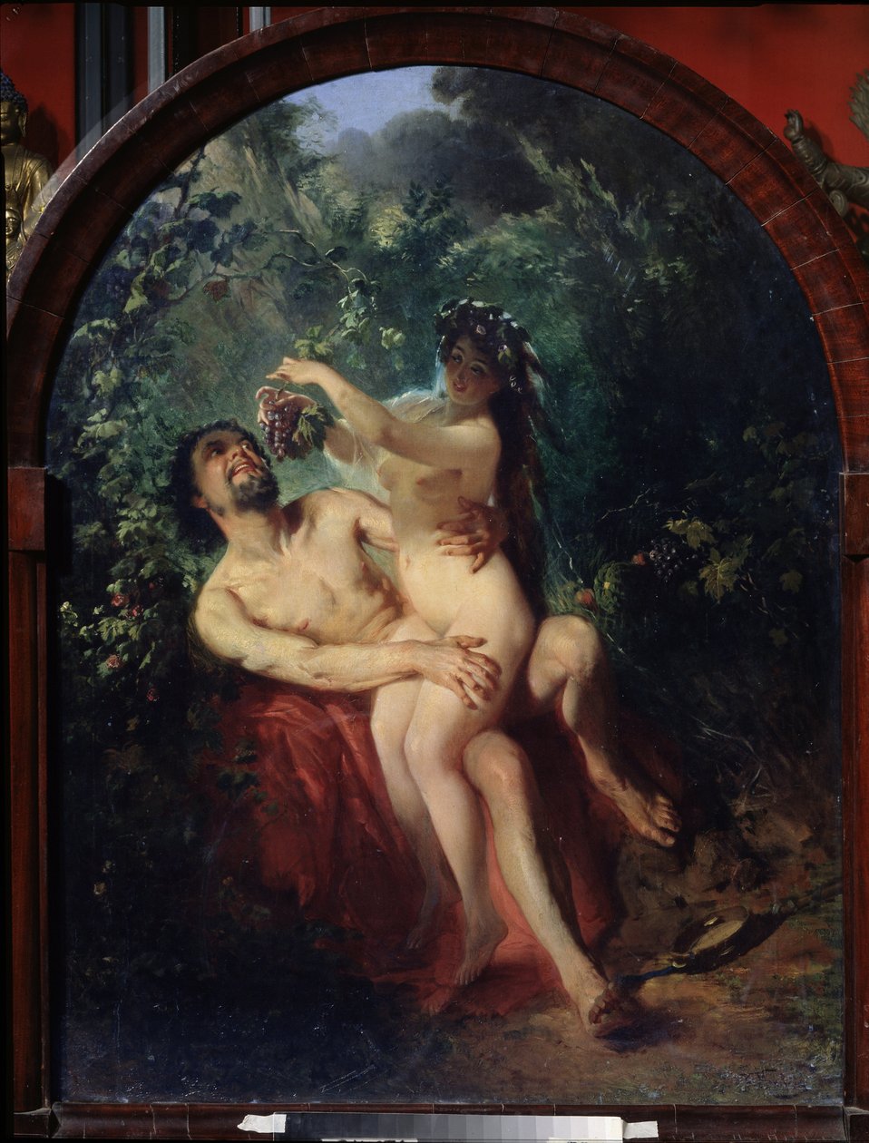 Satyr og nymfe. (Satyr og nymfe). Nøgent og beruset par, nymfen på satyrens knæ fodrer ham med en klase vindruer, plukket fra vinstokkene, der omgiver dem. Maleri af Konstantin Yegorovich Makovsky (Constantin Makovsky) (1839-1915), olie af Konstantin Egorovich Makovsky