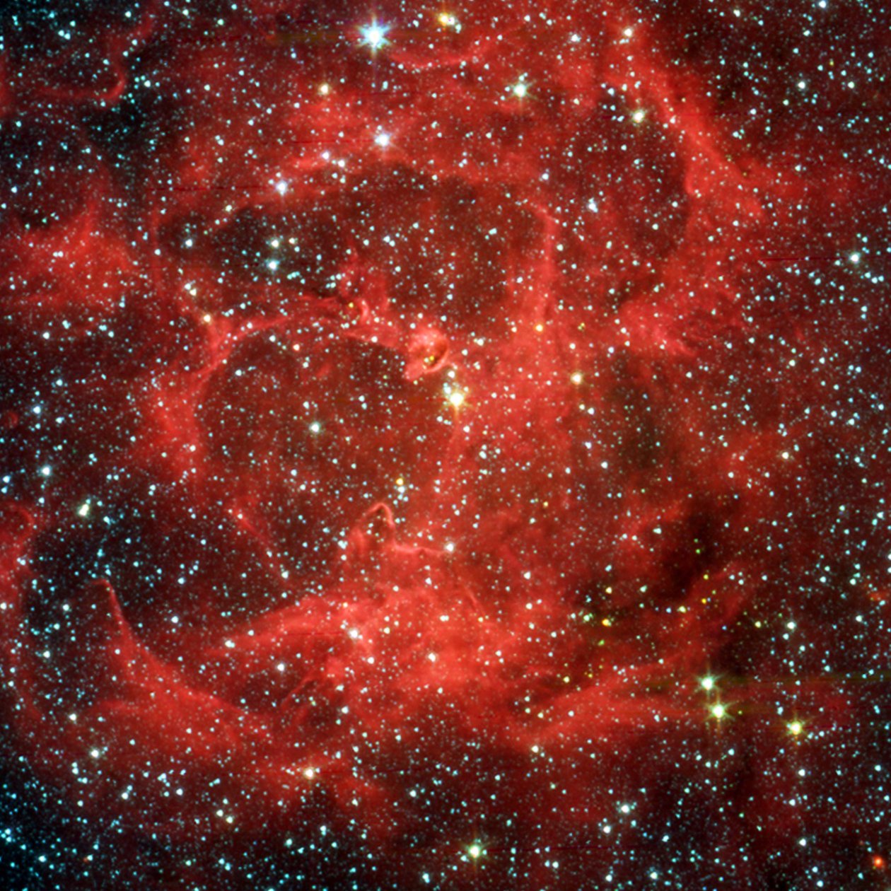 Spitzer Space Telescope-sammenligningsvisninger i synligt lys og infrarødt af den glødende Trifid-tåge, en kæmpe stjernedannende sky af gas og støv, der ligger 5.400 lysår væk i Skytten. Credi af National Aeronautics and Space Administration National Aeronautics and Space Administration