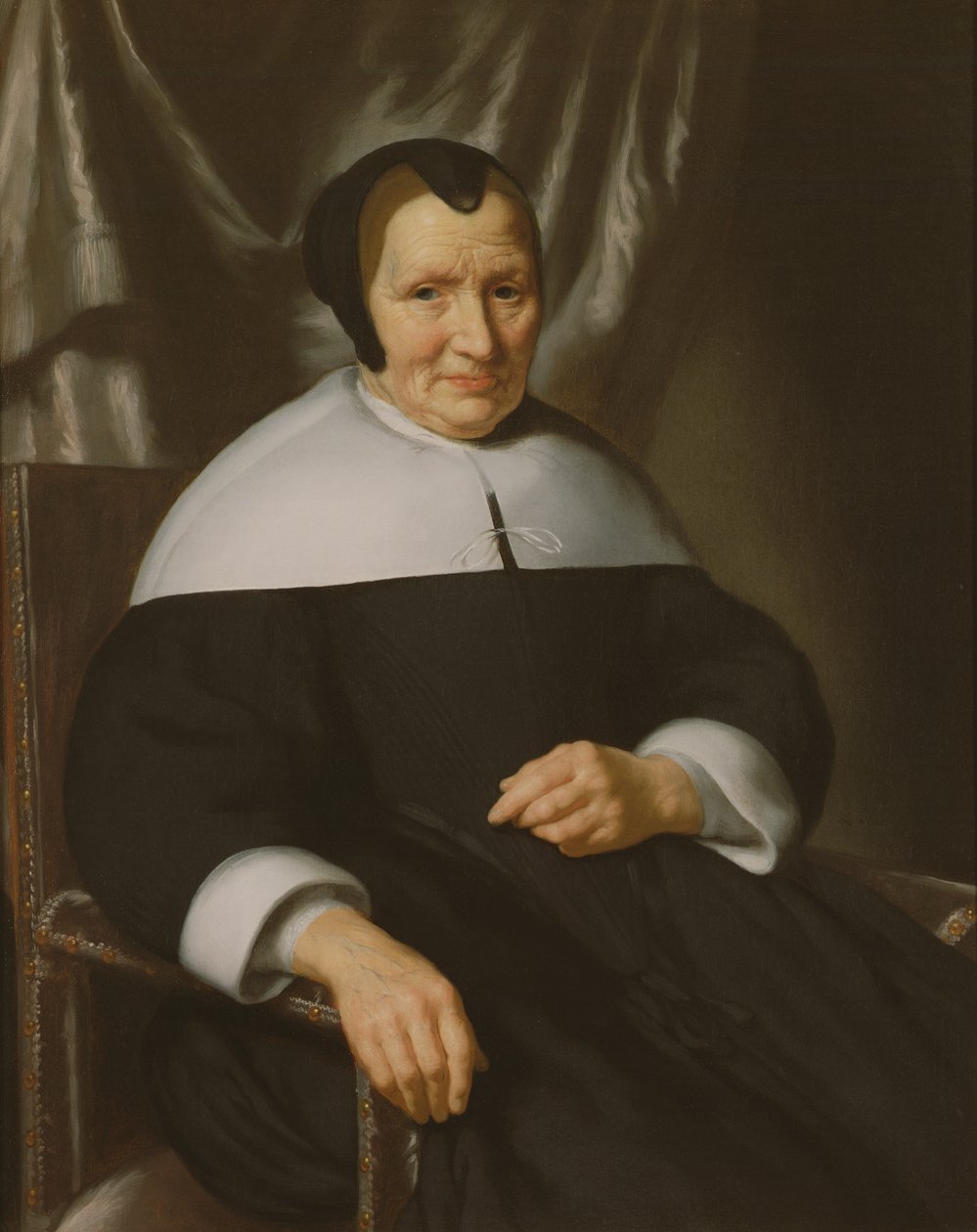 Portræt af en dame, der sidder i en lænestol af Nicolaes Maes