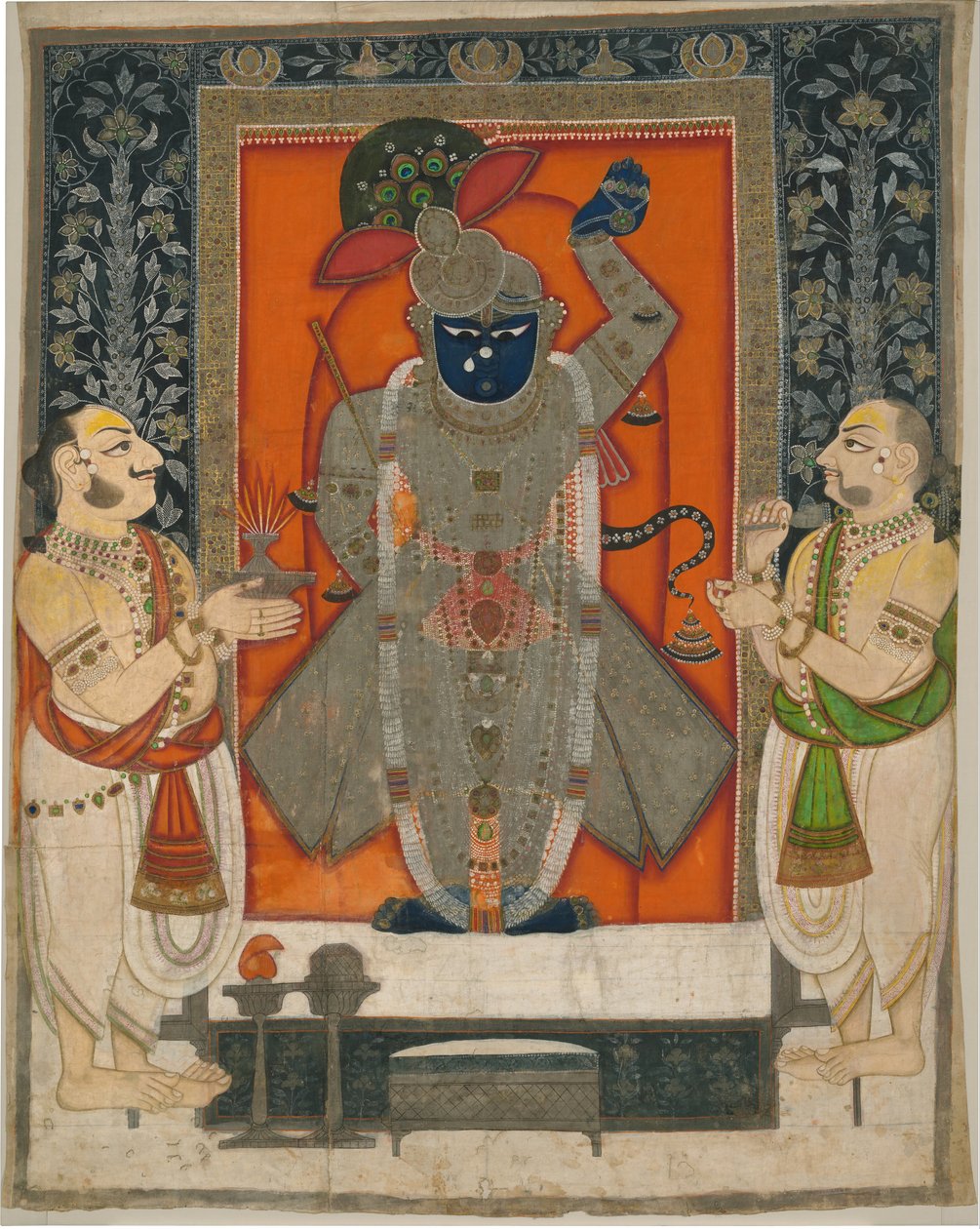 Præster, der tilbeder Krishna som Shrinathji til Mountain of Food -festivalen [Annakuta utsava]; helligdom hængende [pichhavai] af Rajasthan Kota school