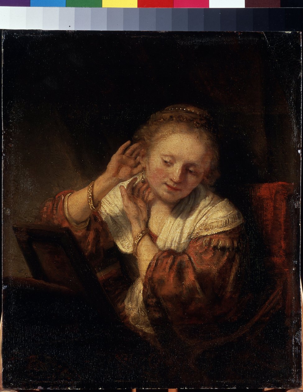 Ung kvinde prøver øreringe. Ung kvinde prøver øreringe. Maleri af Harmenszoon van Rijn kendt som Rembrandt (1606-1669) af Rembrandt Harmensz. van Rijn