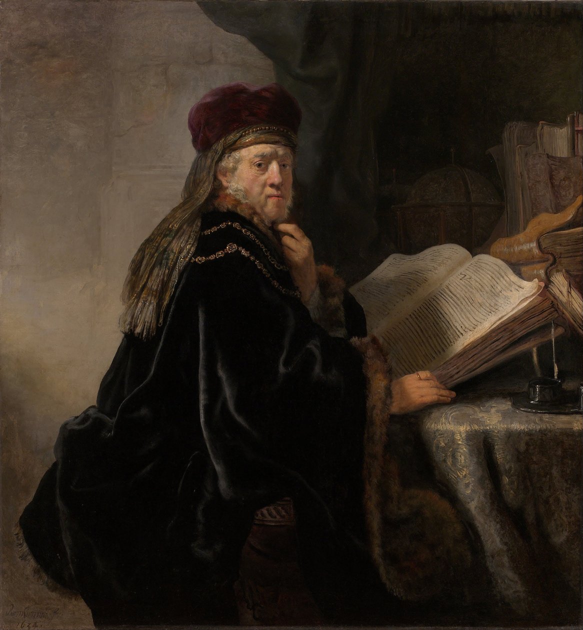 En lærd, der sidder ved en skrivebordslærd ved sit studie af Rembrandt van Rijn