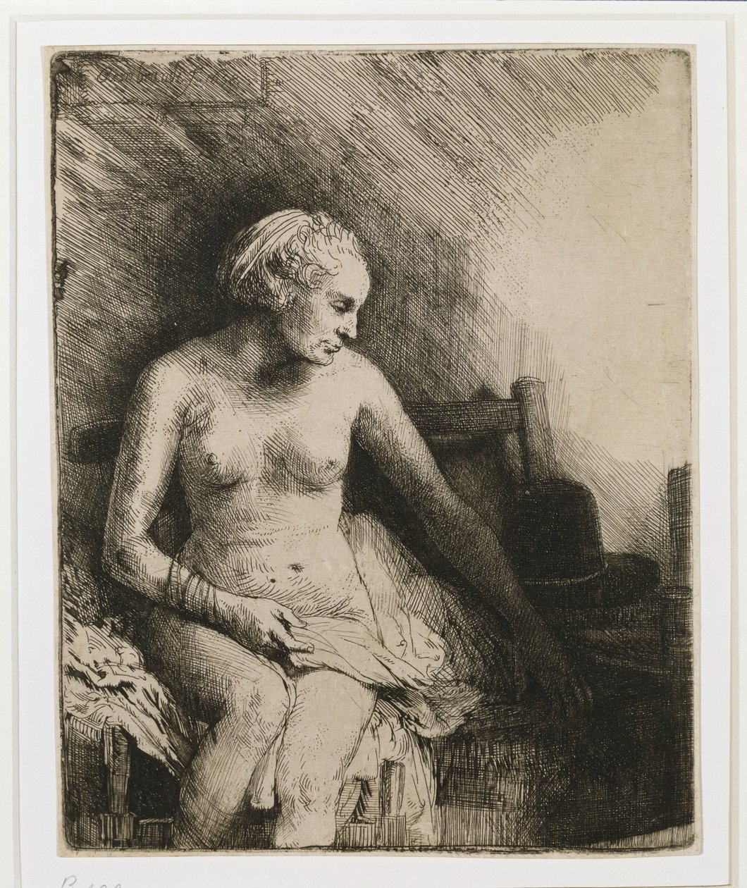 En kvinde ved badet med en hat ved siden af sig, 1658 af Rembrandt van Rijn