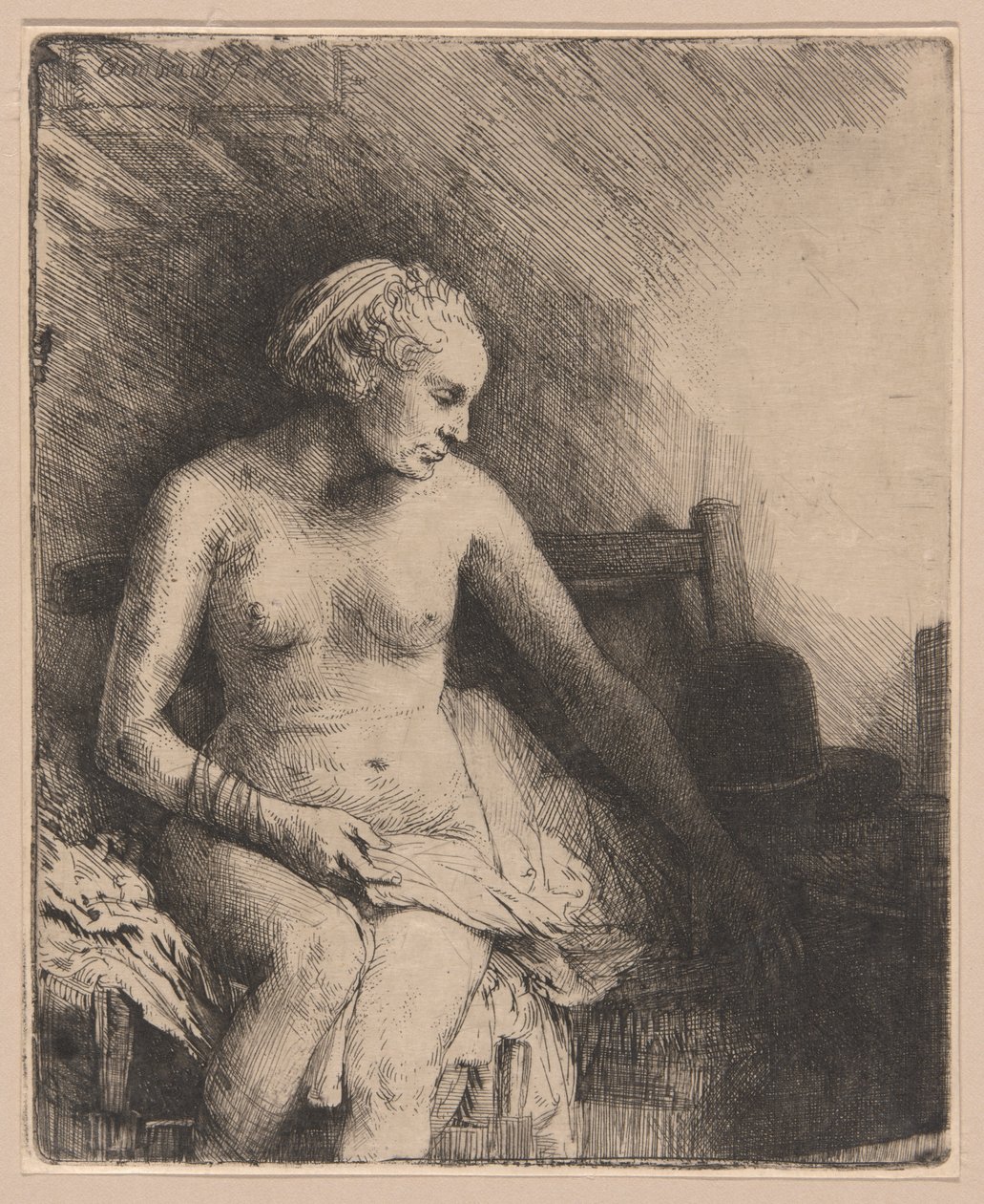 Kvinde ved badet med en hat ved siden af hende af Rembrandt van Rijn