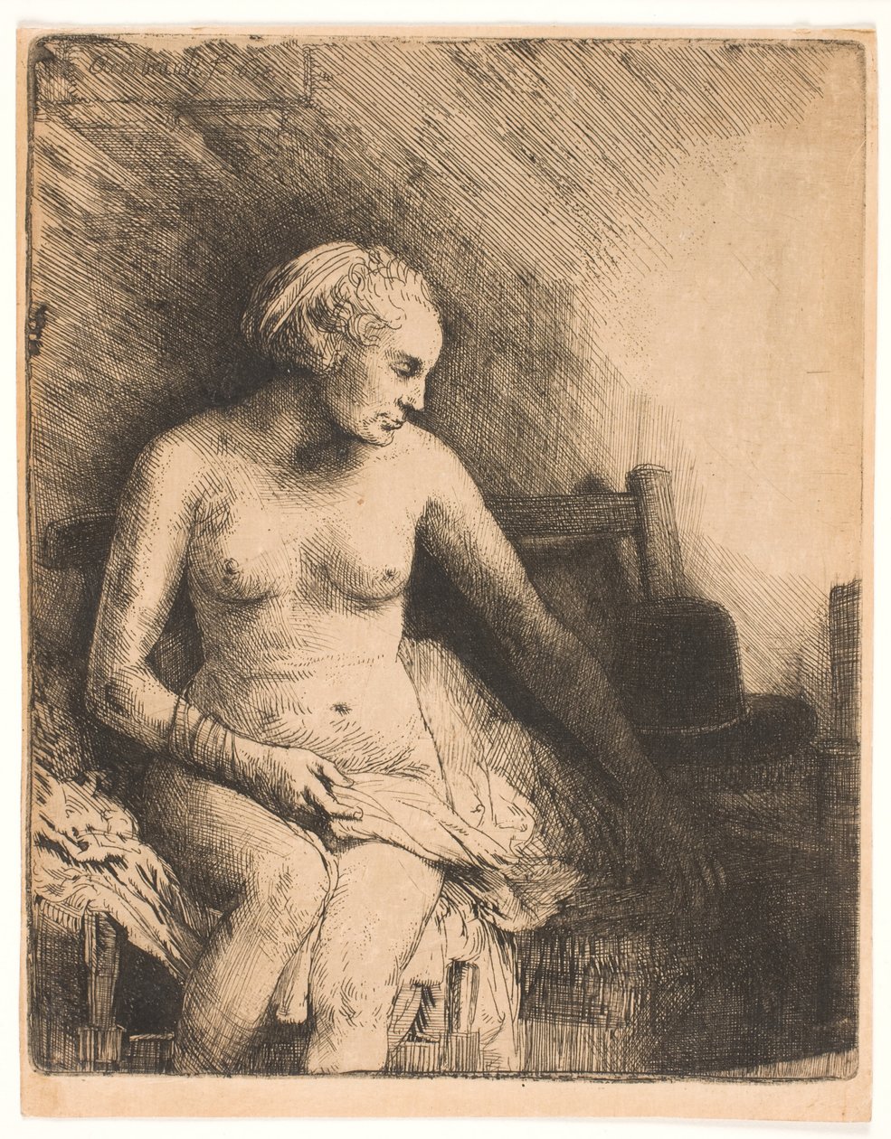 Kvinde ved badet med en hat ved siden af sig af Rembrandt van Rijn