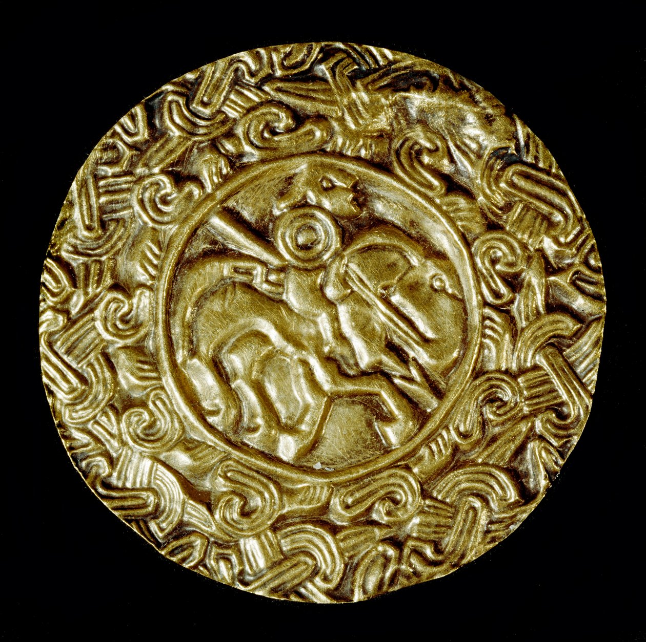 Middelalderens arkæologi (middelalderen). Barbarisk kunst fra Lombardiet: guldskive. I midten er en helgen til hest med spyd og omkring dyremotiver. Lombard kunst, omkring 600. Dim: 47 cm Italien, Cividale del Friuli, Arkæologisk Museum af School Lombard
