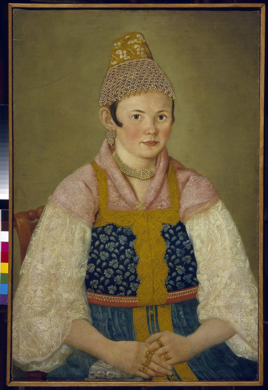 Portræt af en købmands kone, hovedbeklædning af den traditionelle kokoshnik. (Portræt af en købmandskvinde i Kokoshnik Kabluchok). Hun bærer også den traditionelle russiske kjole (sarafane) dekoreret med broderi, med en bluse med blondeærmer, hendes hovedb af School Russian