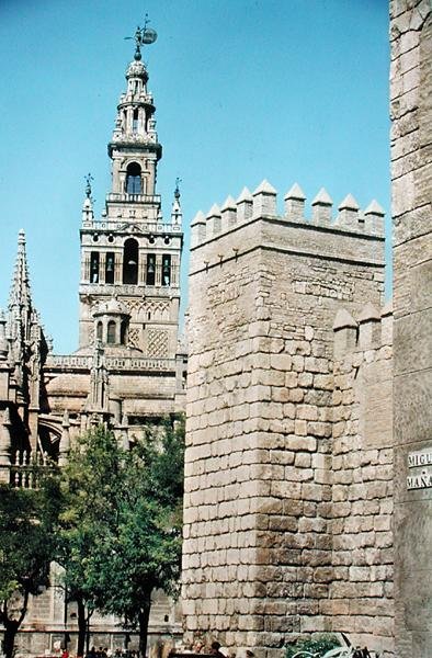 Udsigt over La Giralda-tårnet og et af tårnene i Reales Alcazares af Spanish School