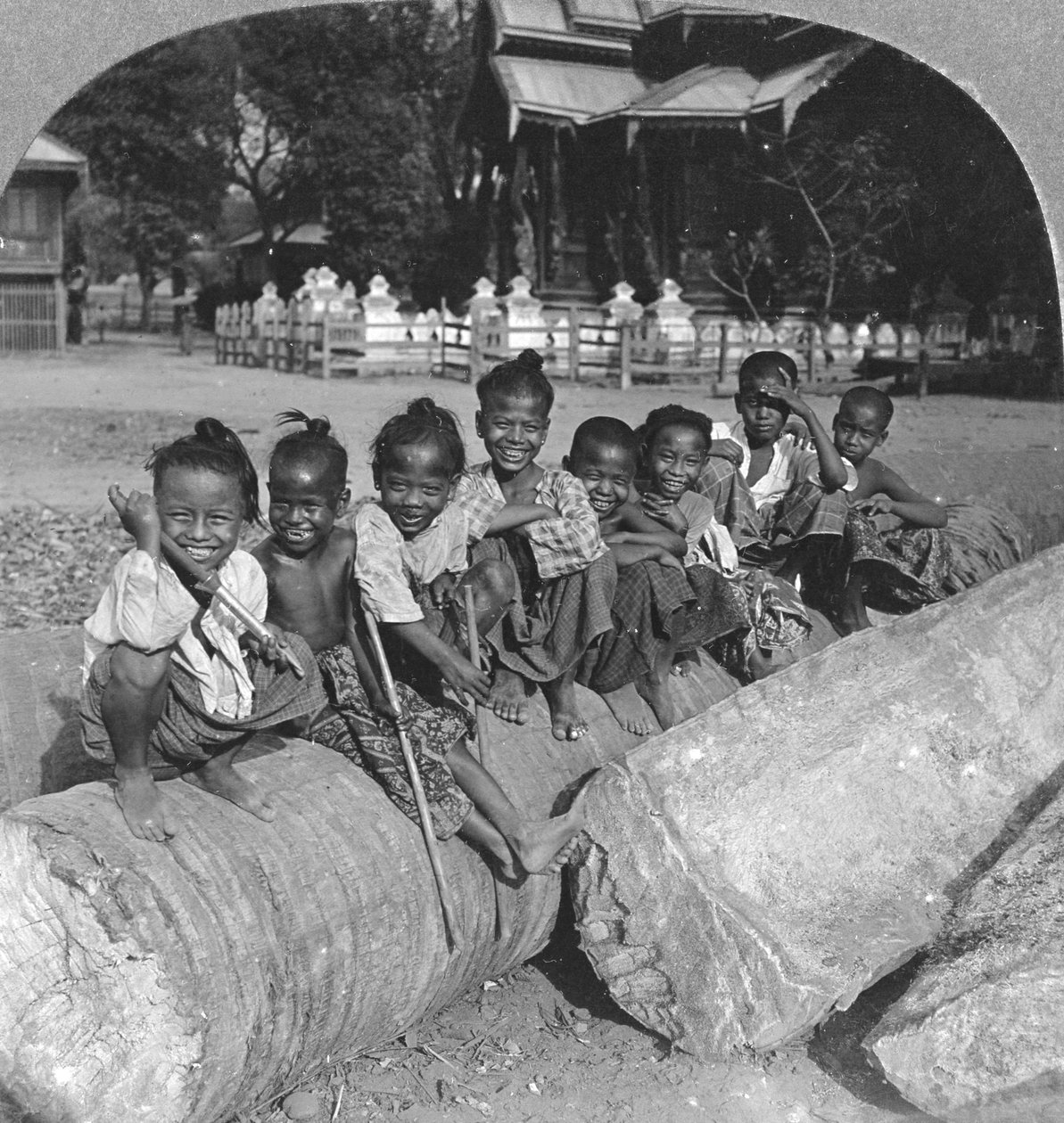 Burmesiske børn siddende på en palmebjælke, Burma, 1908 af Stereo Travel Co