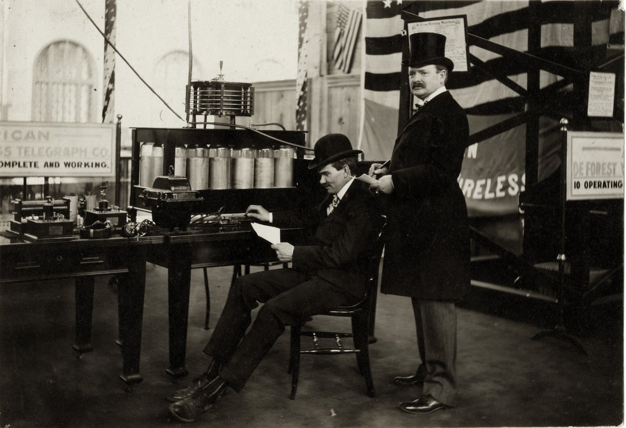 Lee DeForest (siddende) sender en trådløs telefonbesked i Department of Electricity ved verdensudstillingen i 1904 af Unbekannt