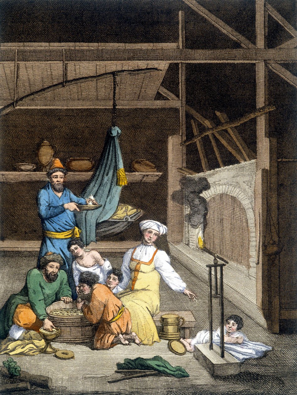 Inde i et russisk hus, en familie ved frokosttid. af Unknown artist