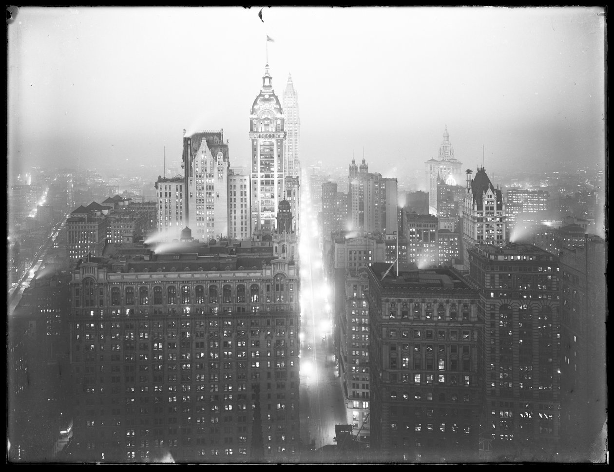 Højvinklet, tåget natudsigt over nedre Manhattan, der ser mod nord, med Singer Building, Woolworth Building og Municipal Building synlig, ca. 1913 af William Davis Hassler