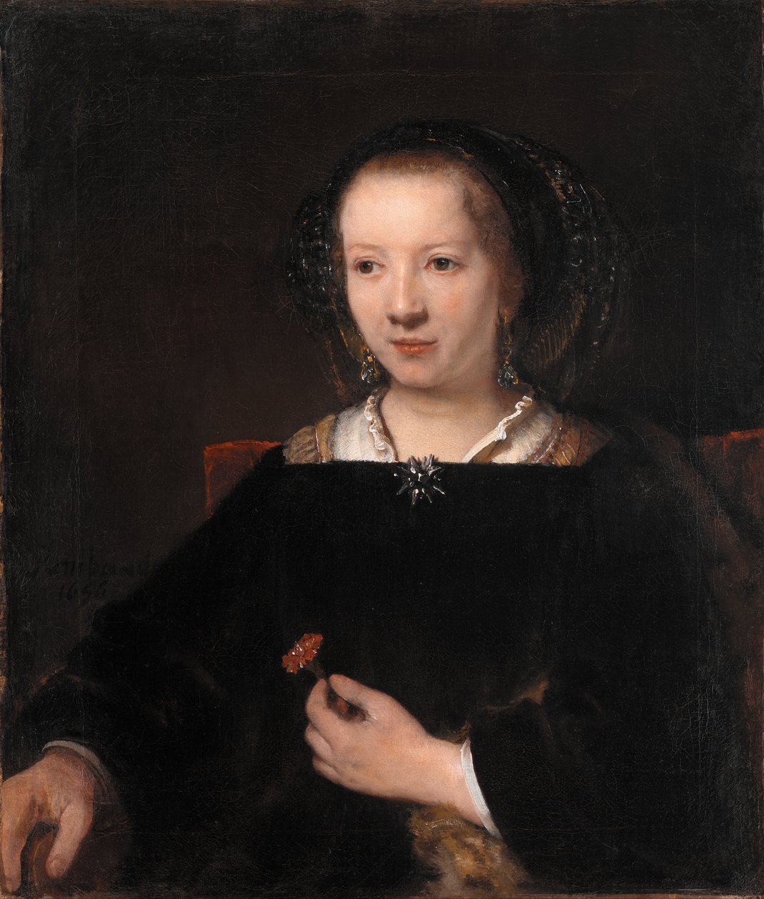 Ung kvinde med en nellike af Workshop of Rembrandt van Rijn