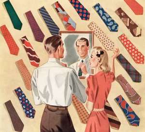 Mand retter sit slips i spejlet midt i en udstilling af mange mænds slips af American School