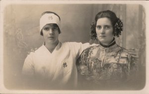 To unge kvinder med armene om hinandens skuldre (s/h foto) af English Photographer