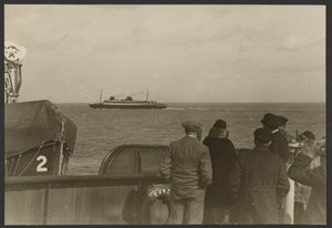 [Gruppe af mennesker på dækket af et skib, der ser et andet skib sejle forbi i det fjerne]. af Erich Salomon