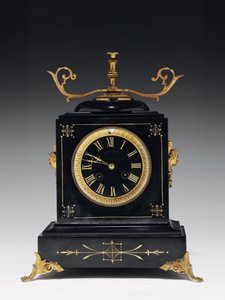 A mantle clock of black composition stone, with incised decoration, with legs, finials and fittings in gilt brass, by Jausions of Pau, France, c.1876-78dani af French School
