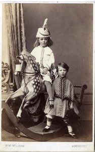 Ung pige med hat på gyngehest med en anden pige stående, 1860
