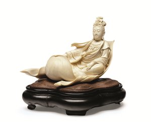En elfenbensudskæring af Kannon, der flyder på et lotusblad, Meiji-periode, slutningen af det 19. århundrede (elfenben med træstativ) af Ishikawa Komei