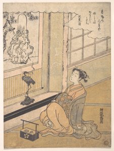 En ung kvinde, der sidder i et værelse og ser på et kakemono med Fukurokujin af Isoda Koryusai