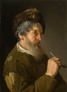 En skægget mand, der holder et rør