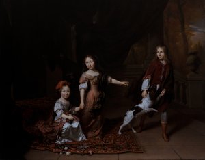 Børn leger med en hund i en stue