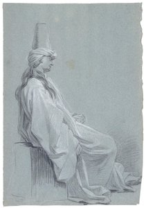 En ung mand sidder i et orientalsk kostume