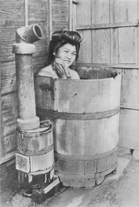 Badet er en stor tønde med kulovn. Ofte udendørs, c1900, 1921