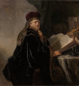 En lærd, der sidder ved en skrivebordslærd ved sit studie af Rembrandt van Rijn