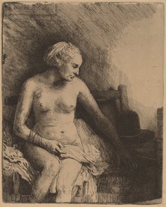 Kvinde ved badet med en hat ved siden af hende af Rembrandt van Rijn