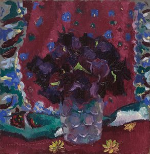 Blå stedmoderblomster i et glas