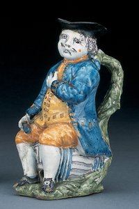 Toby kande med bleg mangan ansigt og hænder, holdende og tom kugleformet buff-farvet kande i vasket blå jakke og ridebukser og grøn vest, ca. 1800 af Unbekannt