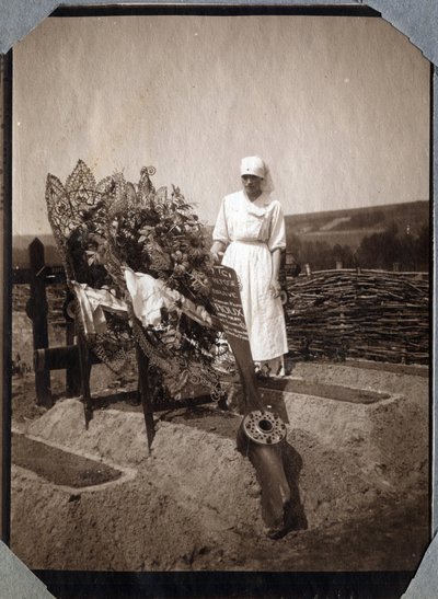 Første Verdenskrig 1914-1918: Sygeplejerske (Therese Pavillou?) i en bluse på graven af den franske pilotsergent Roux, der døde i en alder af 21, i Couville, Manche, Basse-Normandie (Nedre Normandiet), Frankrig. Anonymt fotografi juli 1917. Privat samling, af Anonymous Anonymous