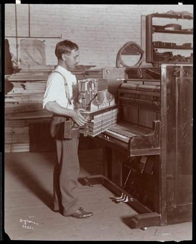 Mand, der arbejder i Hardman, Peck und Co. klaverfabrikken, New York, 1907 (sølv gelatinetryk) af Byron Company